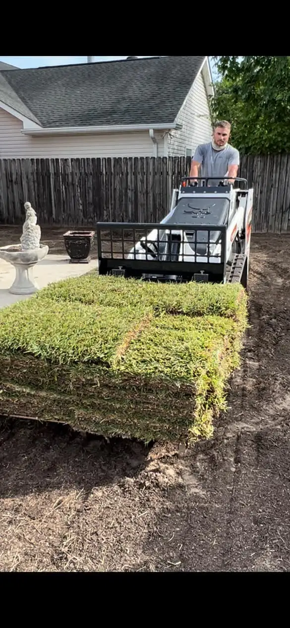 A residential backyard prepared for new sod installation, featuring bare soil ready for transformation, serviced by Southern Grounds LLC.