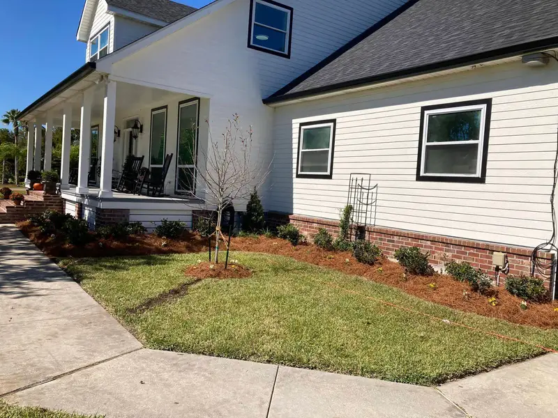 Southern Grounds LLC's landscaping work displaying a perfectly manicured garden with a mix of ornamental shrubs and flowering plants in New Orleans.