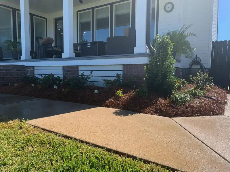 Southern Grounds LLC's landscaping work displaying a perfectly manicured garden with a mix of ornamental shrubs and flowering plants in New Orleans.