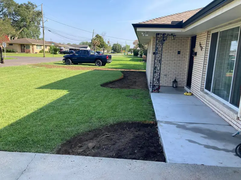 Expertly designed backyard landscape with a variety of lush green plants and trees, showcasing Southern Grounds LLC's attention to detail in New Orleans.