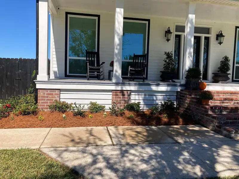 Southern Grounds LLC's landscaping work displaying a perfectly manicured garden with a mix of ornamental shrubs and flowering plants in New Orleans.
