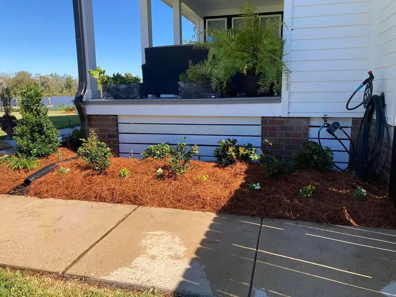 Southern Grounds LLC's landscaping work displaying a perfectly manicured garden with a mix of ornamental shrubs and flowering plants in New Orleans.