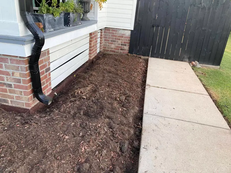Southern Grounds LLC's landscaping work displaying a perfectly manicured garden with a mix of ornamental shrubs and flowering plants in New Orleans.