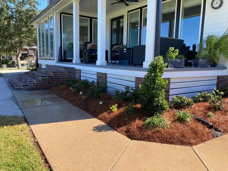 Southern Grounds LLC's landscaping work displaying a perfectly manicured garden with a mix of ornamental shrubs and flowering plants in New Orleans.