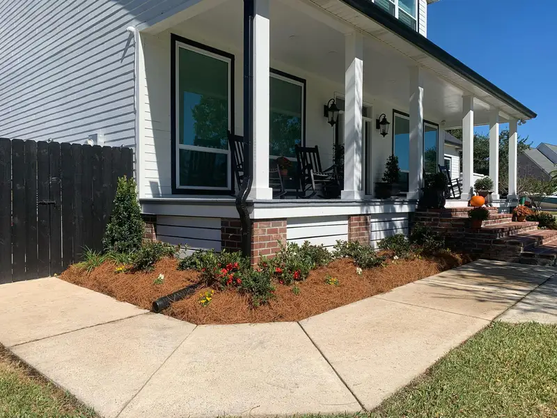 Southern Grounds LLC's landscaping work displaying a perfectly manicured garden with a mix of ornamental shrubs and flowering plants in New Orleans.