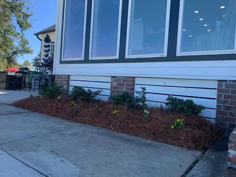 Southern Grounds LLC's landscaping work displaying a perfectly manicured garden with a mix of ornamental shrubs and flowering plants in New Orleans.