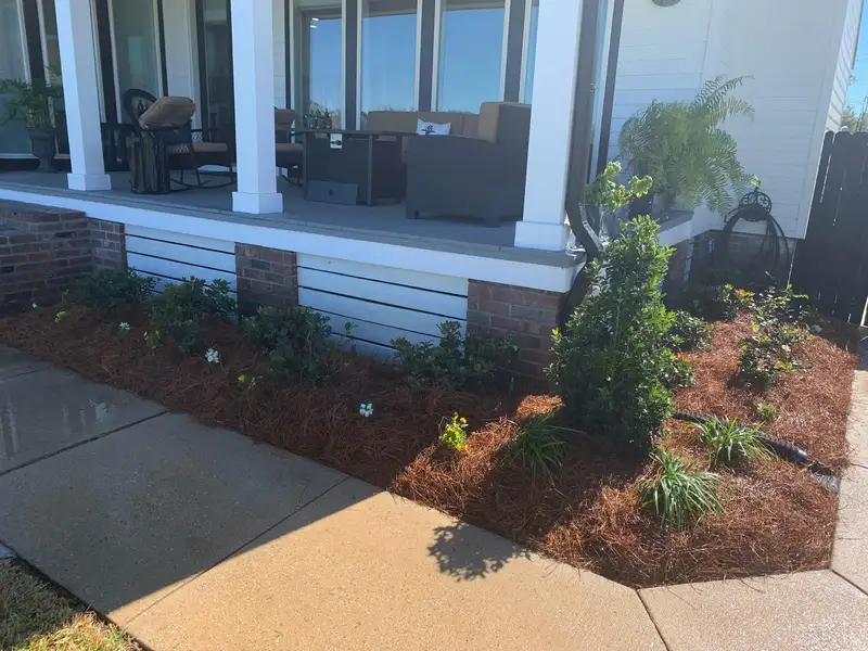 Southern Grounds LLC's landscaping work displaying a perfectly manicured garden with a mix of ornamental shrubs and flowering plants in New Orleans.