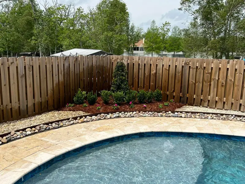 Elegant residential garden landscaped by Southern Grounds LLC, featuring a balanced combination of evergreens and seasonal flowers in New Orleans.