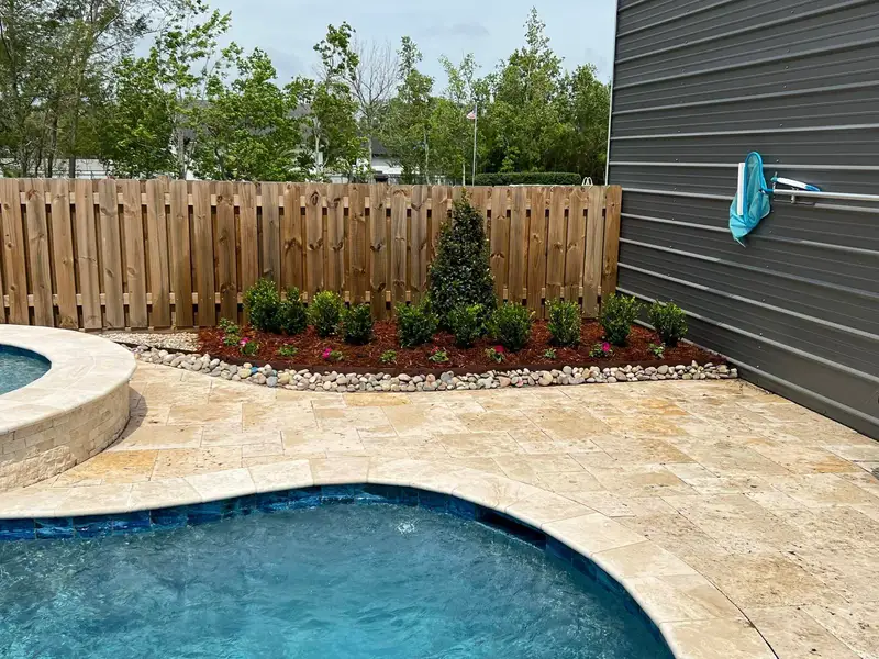 Elegant residential garden landscaped by Southern Grounds LLC, featuring a balanced combination of evergreens and seasonal flowers in New Orleans.