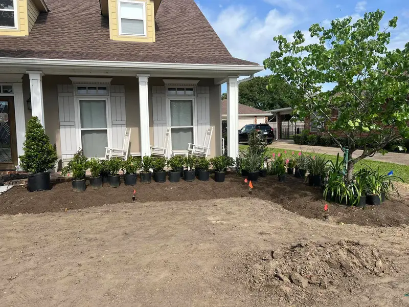 Elegant residential garden landscaped by Southern Grounds LLC, featuring a balanced combination of evergreens and seasonal flowers in New Orleans.