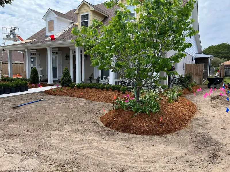 Elegant residential garden landscaped by Southern Grounds LLC, featuring a balanced combination of evergreens and seasonal flowers in New Orleans.