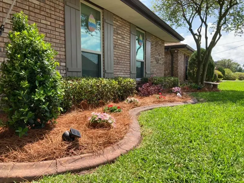 Beautiful landscaping flowerbeds with mulch crafted and installed by Southern Grounds, LLC in the greater new orleans area