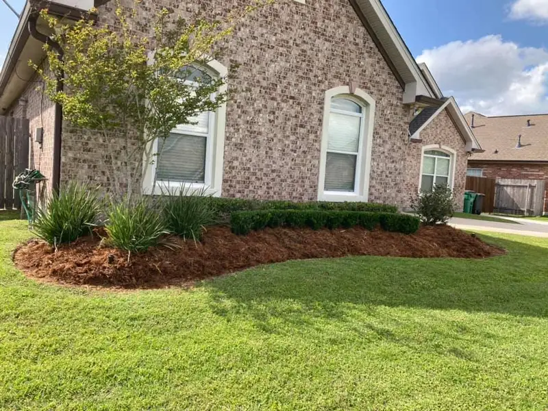 Beautiful landscaping flowerbeds with mulch crafted and installed by Southern Grounds, LLC in the greater new orleans area