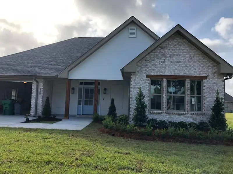 Beautiful landscaping flowerbeds with mulch crafted and installed by Southern Grounds, LLC in the greater new orleans area