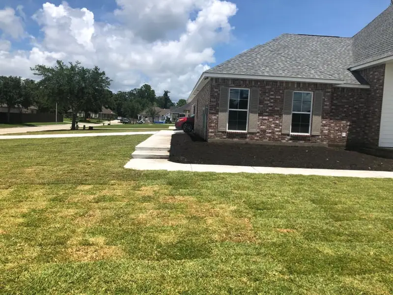 Beautiful landscaping flowerbeds with mulch crafted and installed by Southern Grounds, LLC in the greater new orleans area