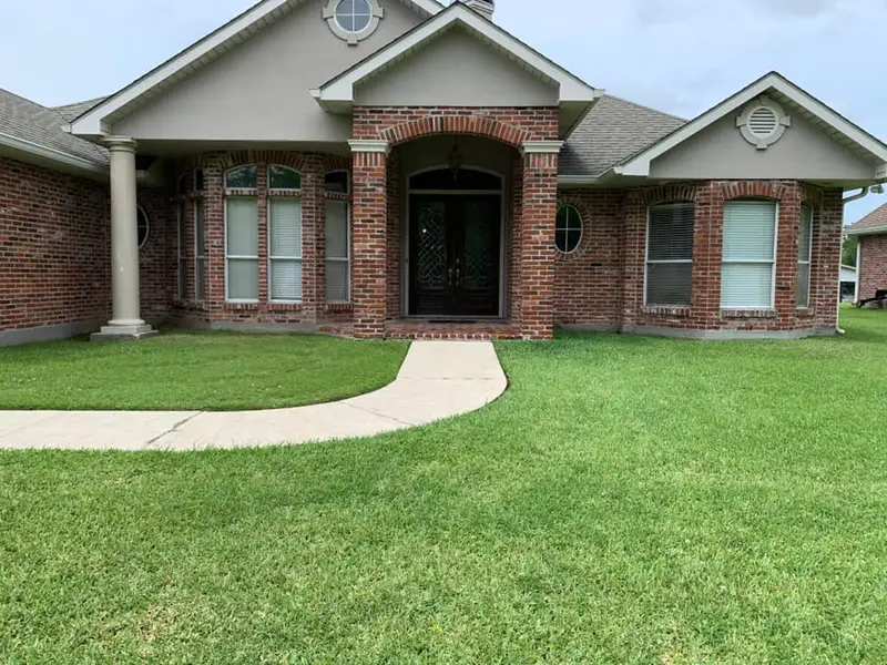 Beautiful landscaping flowerbeds with mulch crafted and installed by Southern Grounds, LLC in the greater new orleans area