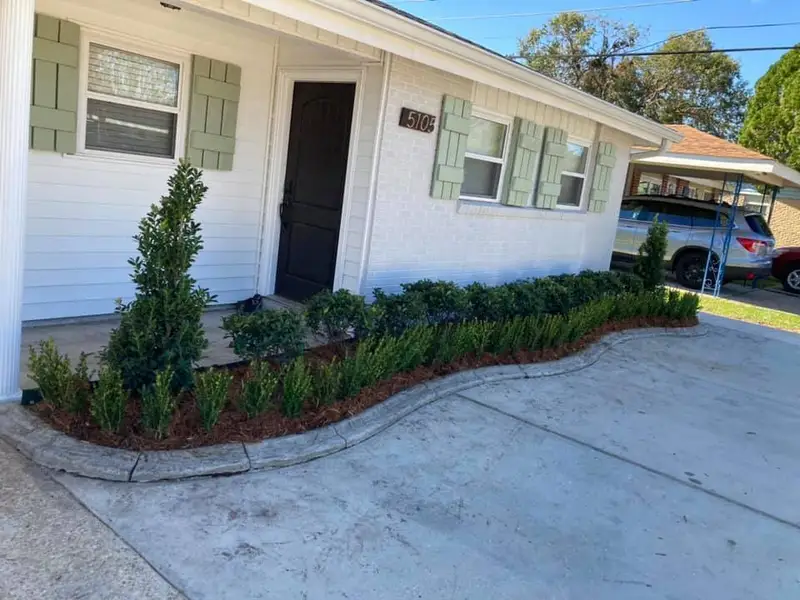 Beautiful landscaping flowerbeds with mulch crafted and installed by Southern Grounds, LLC in the greater new orleans area
