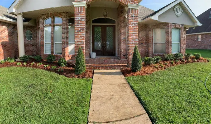 Beautiful landscaping flowerbeds with mulch crafted and installed by Southern Grounds, LLC in the greater new orleans area