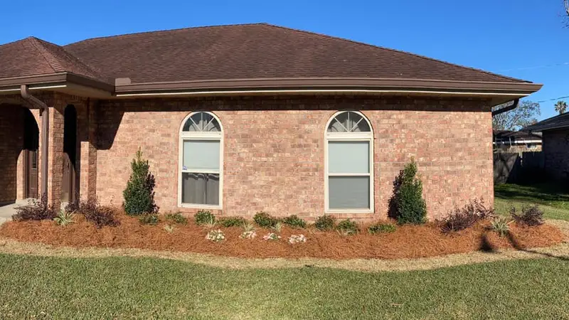 Beautiful landscaping flowerbeds with mulch crafted and installed by Southern Grounds, LLC in the greater new orleans area