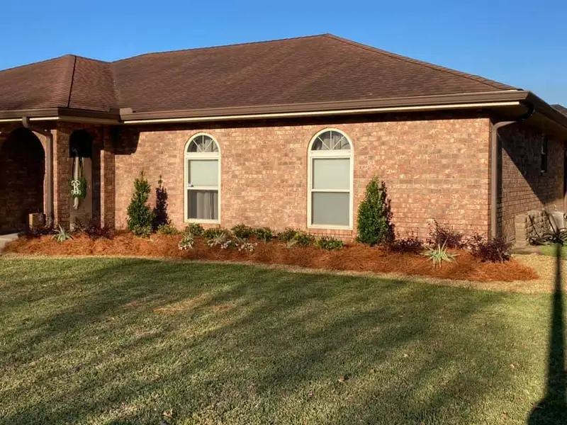 Beautiful landscaping flowerbeds with mulch crafted and installed by Southern Grounds, LLC in the greater new orleans area