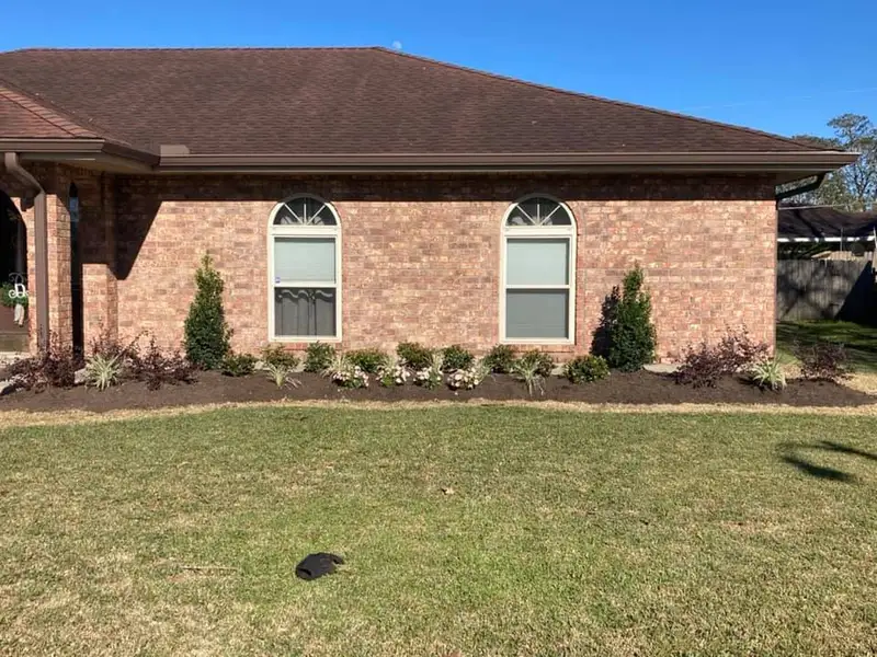Beautiful landscaping flowerbeds with mulch crafted and installed by Southern Grounds, LLC in the greater new orleans area