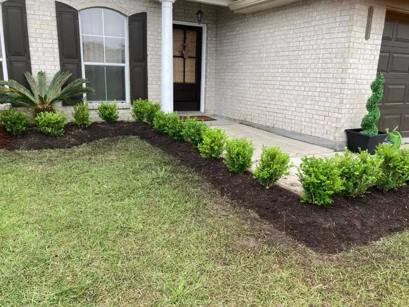 Beautiful landscaping flowerbeds with mulch crafted and installed by Southern Grounds, LLC in the greater new orleans area