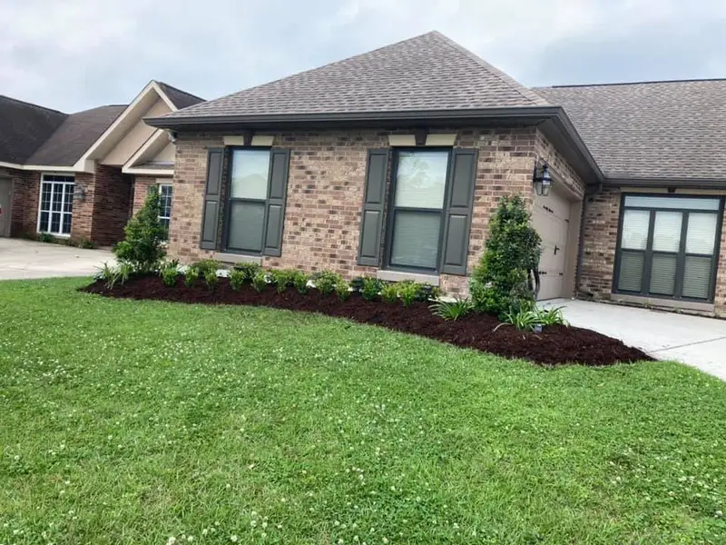 Beautiful landscaping flowerbeds with mulch crafted and installed by Southern Grounds, LLC in the greater new orleans area